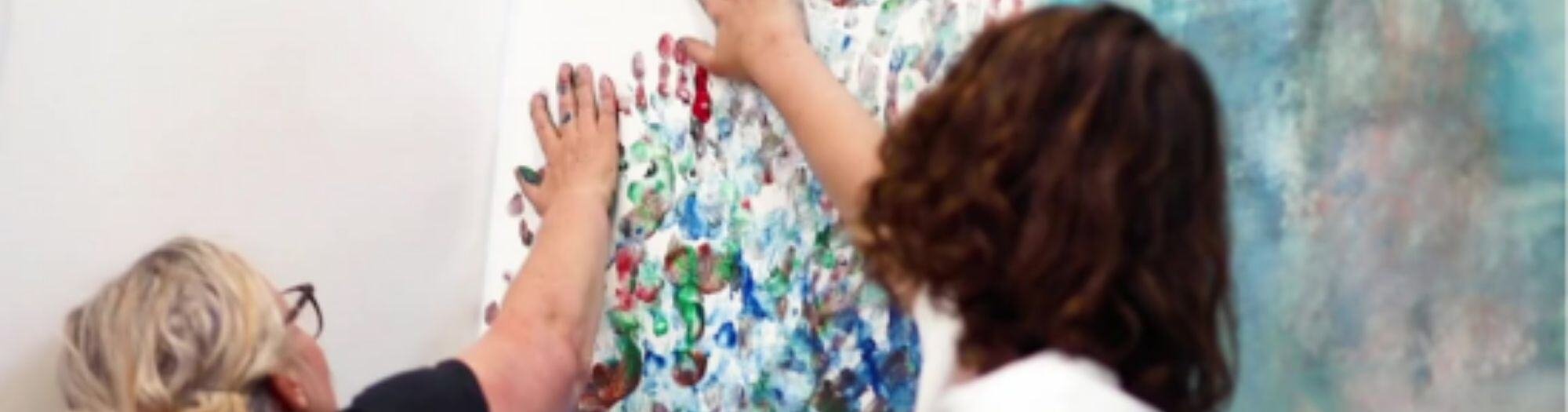 Mum and son painting with hands