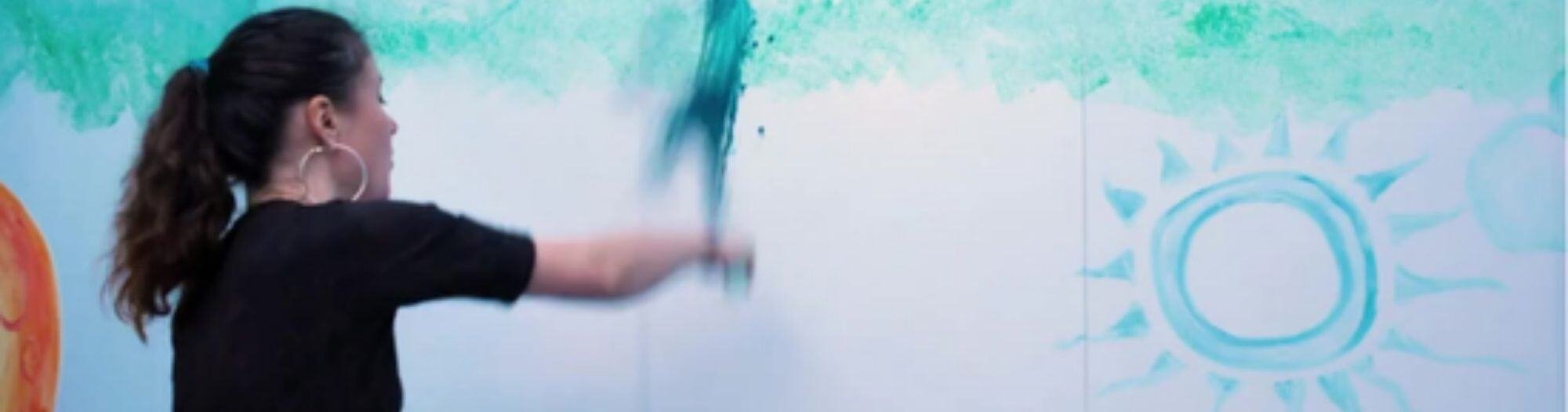 Teenager using a rag to Paint