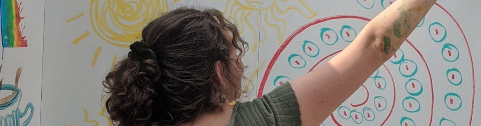 Young Woman Painting the wall