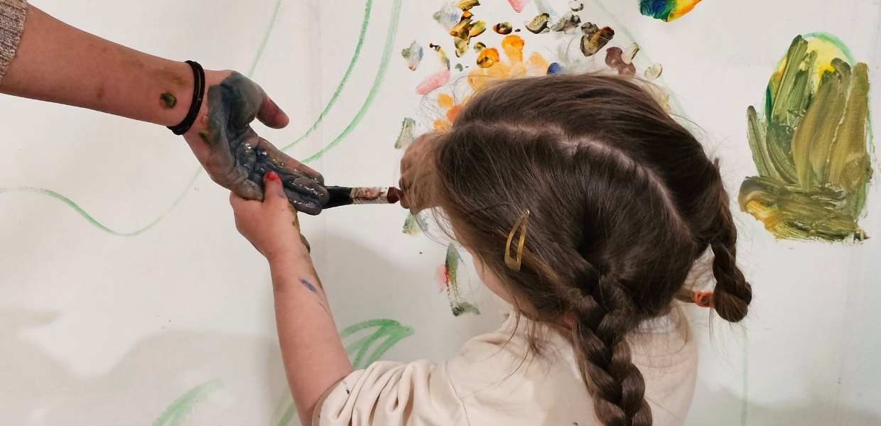 Girl Painting mums hand