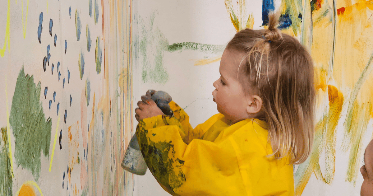 Toddler Paint Girl in yellow overalls