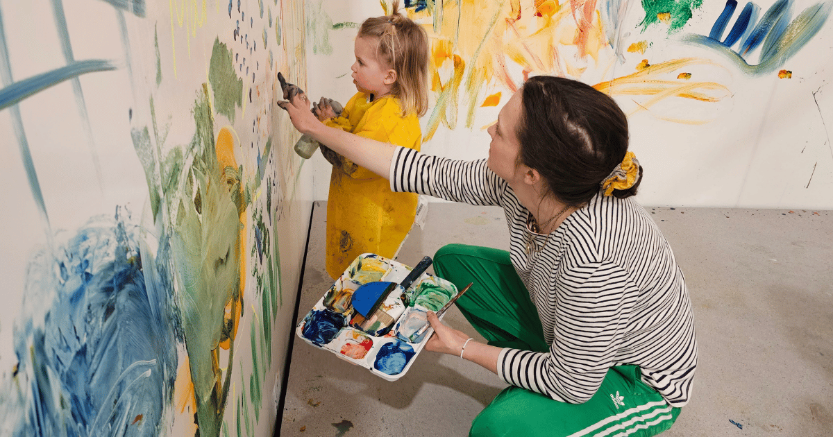 Toddler Paint mum helping her daughter paint