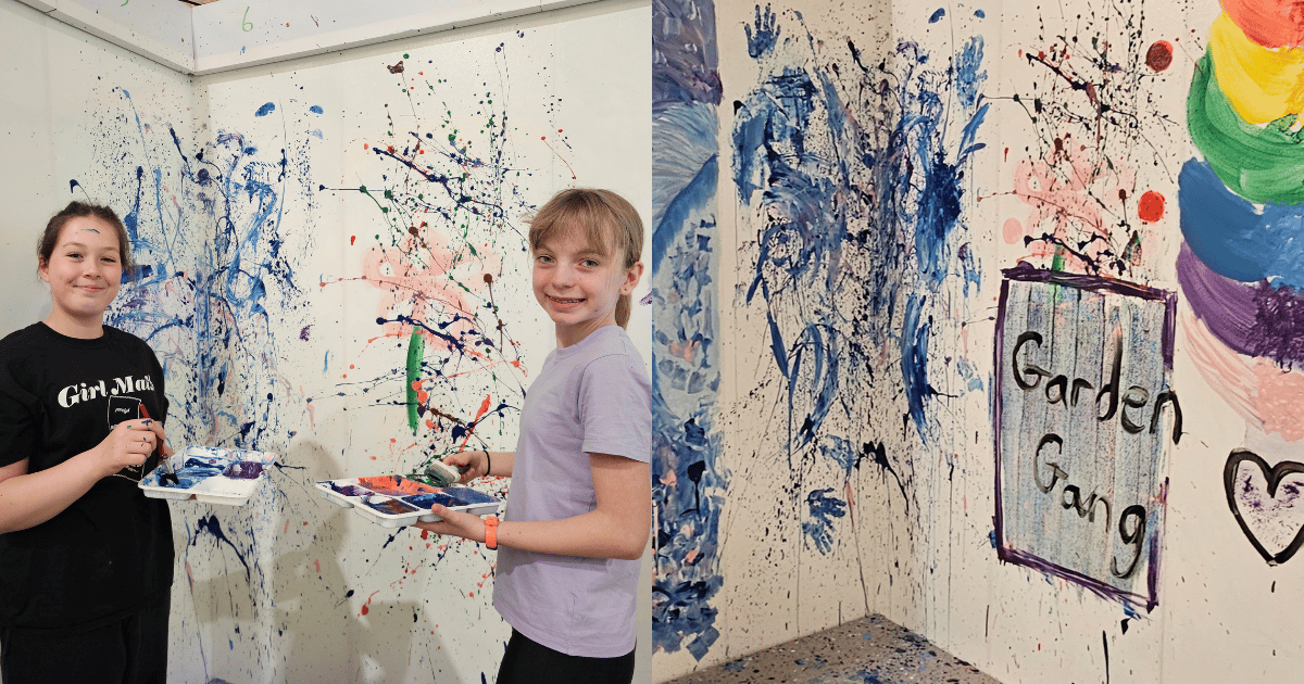Two Girls painting a mural at paintnGo